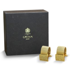 Пара запонок с «золотой» отделкой.